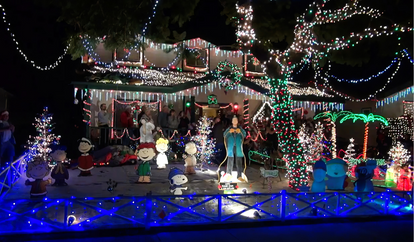 House covered in Christmas lights at night