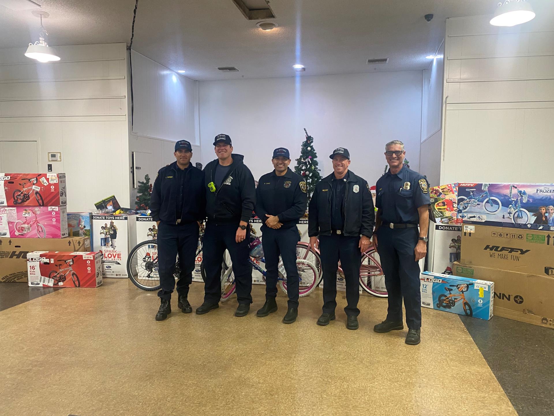 ES Firefighters standing in front of toys