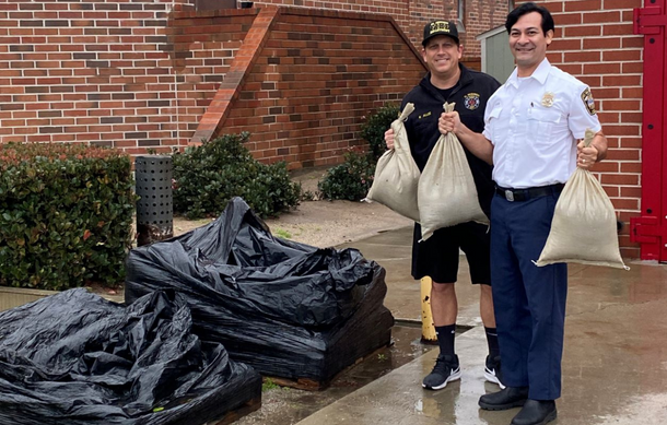 Fire personnel holding sandbags