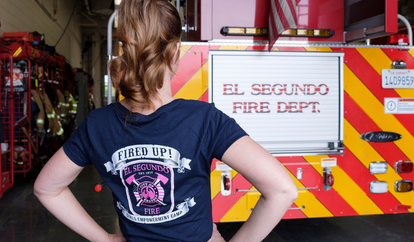 Girl in Fired Up Girls Camp Shirt facing El Segundo Fire Truck