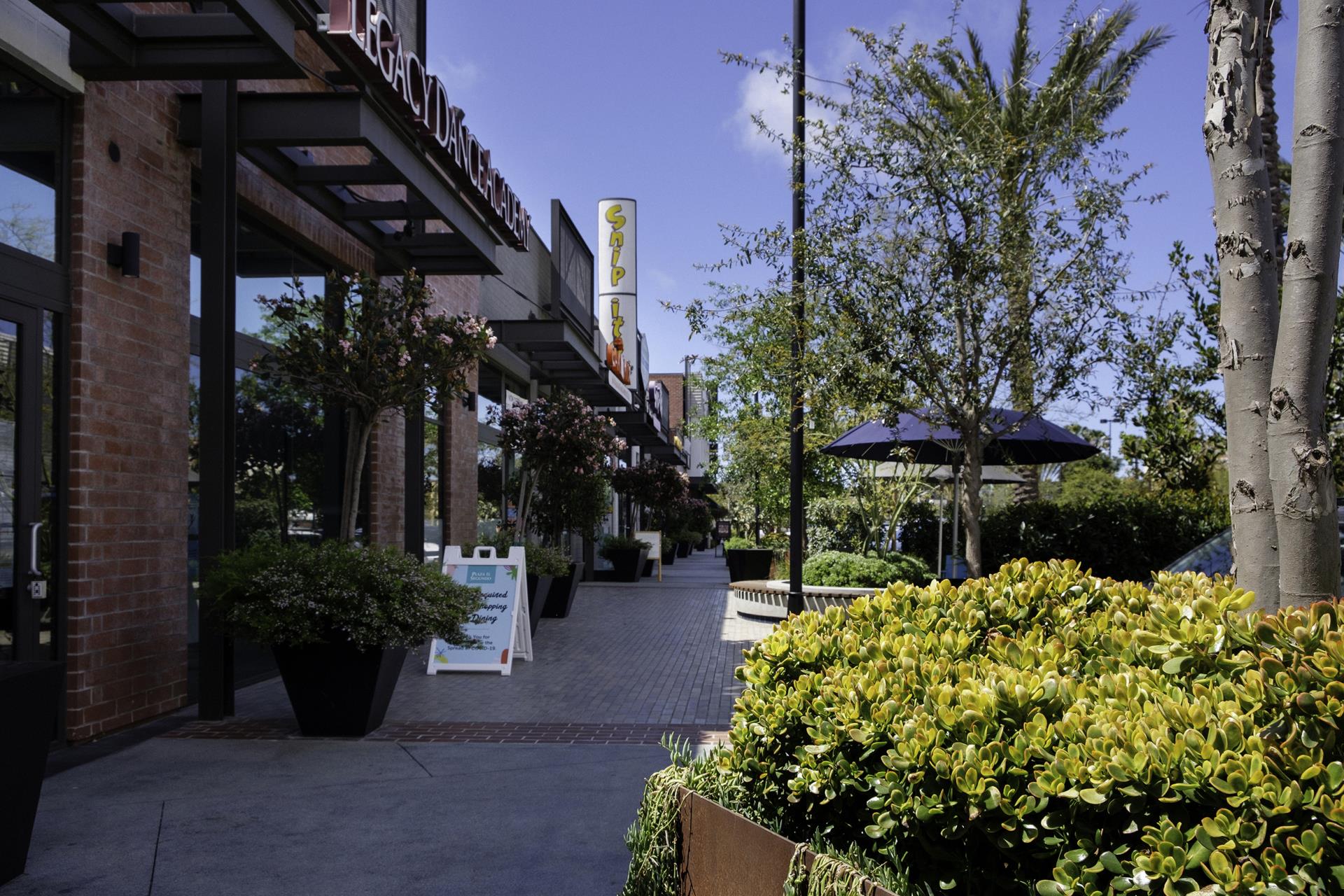 The Works courtyard with shops, trees, and flowers