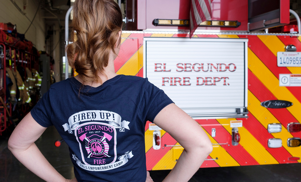 Girl in Fired Up Girls Camp Shirt facing El Segundo Fire Truck