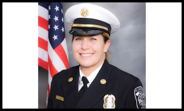 Headshot of Chief Deena Lee in dress uniform in front of American Flag