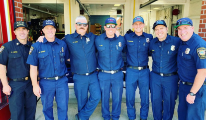 Group photo of 7 firefighters in uniform, smiling