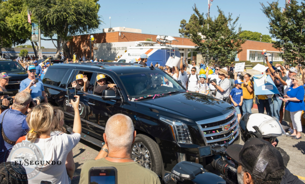 Community cheering with signs welcoming home El Segundo Little League 12U All-Star Team 