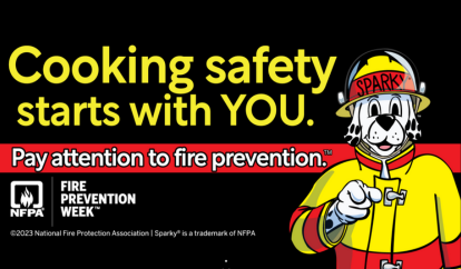 Cartoon Dalmation, Sparky, in fire gear talking about fire safety