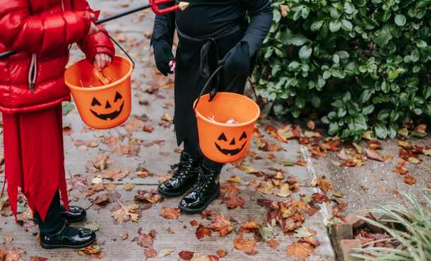 Trick or Treaters in costume with candy buckets