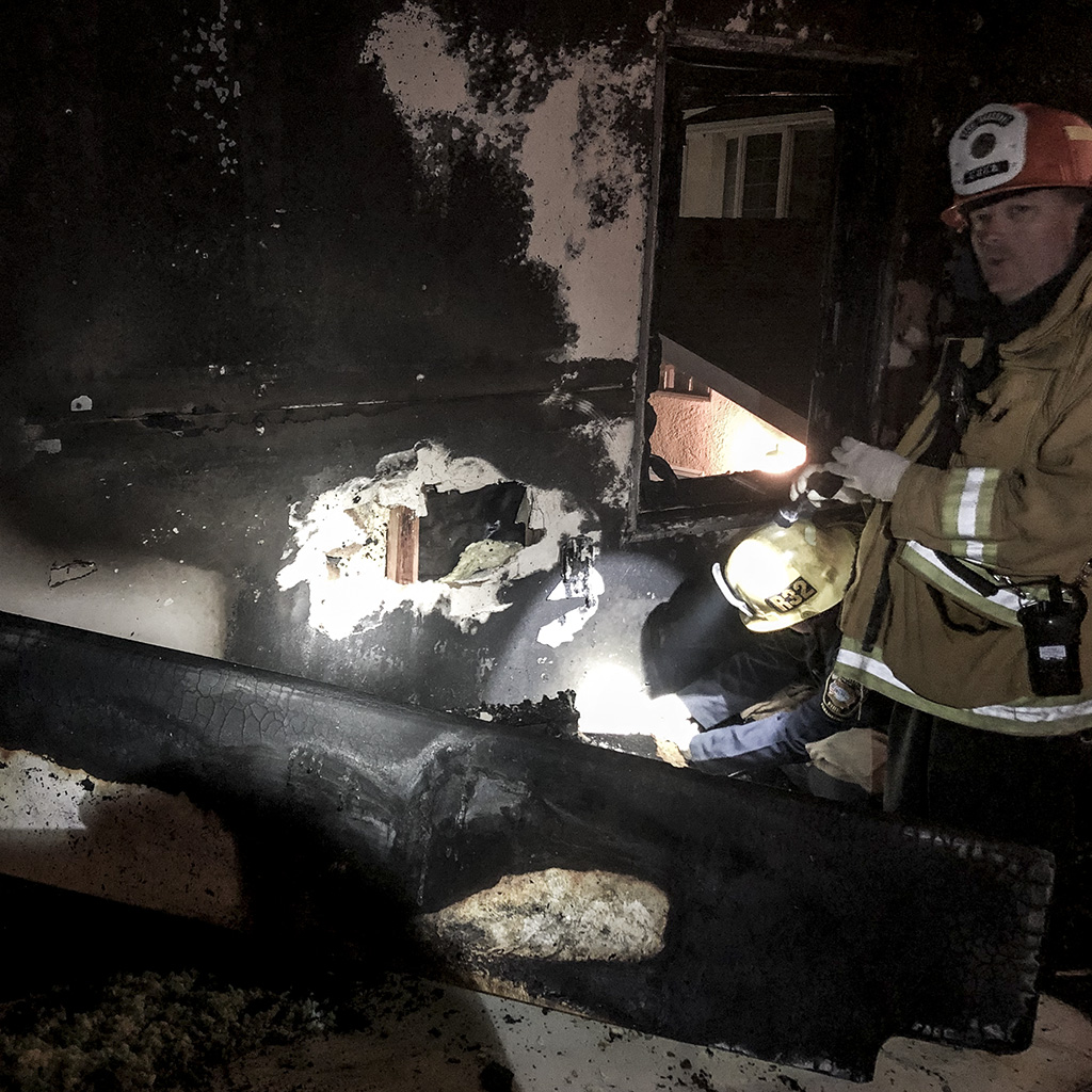 firefighters check for signs of arson after a fire