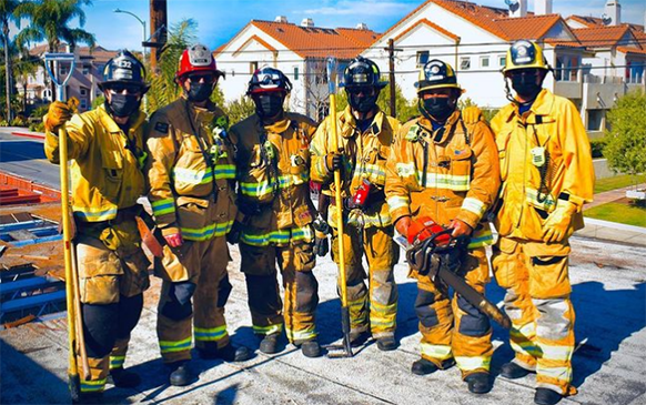 firefighters stand on a roof after practicing Ventilation